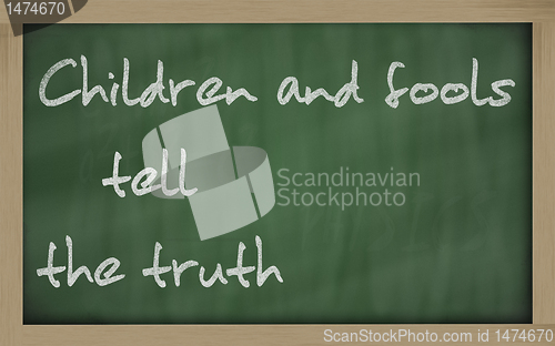 Image of " Children and fools tell the truth " written on a blackboard