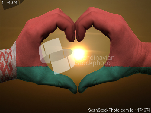 Image of Heart and love gesture by hands colored in belarus flag during b