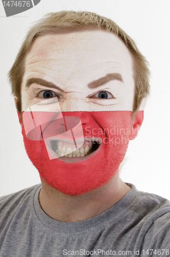 Image of Face of crazy angry man painted in colors of poland flag