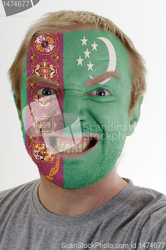 Image of Face of crazy angry man painted in colors of Turkmenistan flag