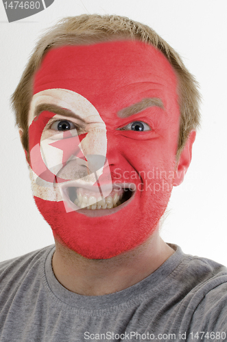 Image of Face of crazy angry man painted in colors of Tunisia flag