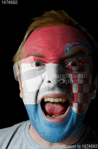 Image of Face of crazy angry man painted in colors of Croatia flag