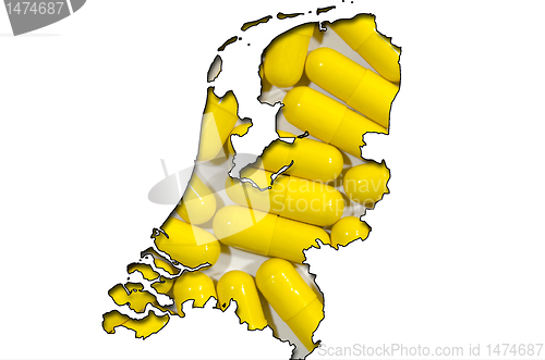 Image of Outline map of Netherlands with pills in background