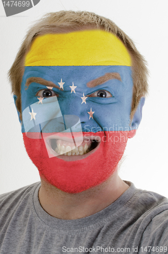 Image of Face of crazy angry man painted in colors of venezuela flag