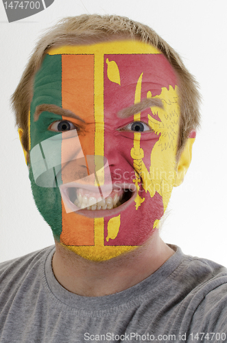 Image of Face of crazy angry man painted in colors of Sri Lanka flag