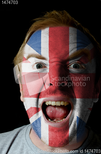 Image of Face of crazy angry man painted in colors of uk flag