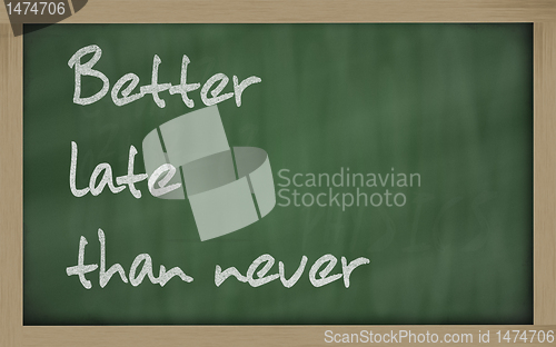 Image of "   Better late than never " written on a blackboard