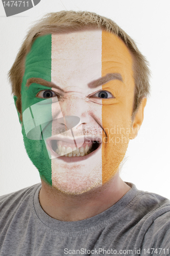 Image of Face of crazy angry man painted in colors of ireland flag