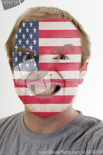 Image of Face of crazy angry man painted in colors of usa flag