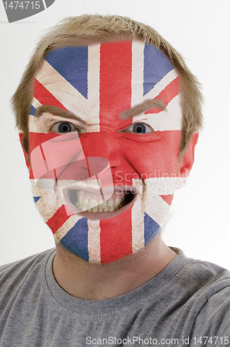 Image of Face of crazy angry man painted in colors of uk flag
