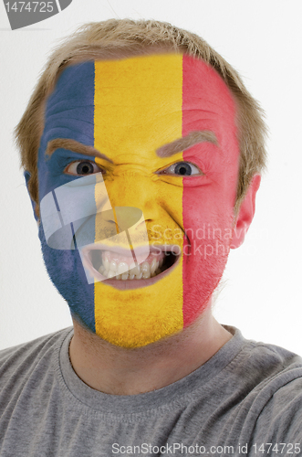 Image of Face of crazy angry man painted in colors of romania flag