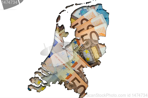 Image of Outline map of Netherlands with euro banknotes in background 