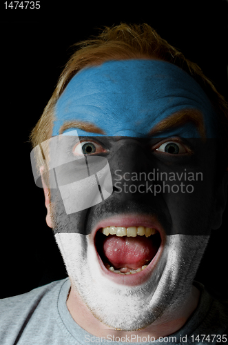 Image of Face of crazy angry man painted in colors of estonia flag