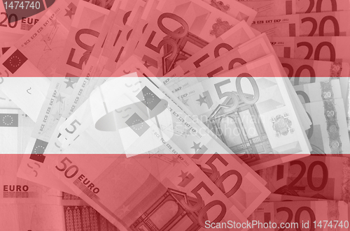 Image of flag of Austria with transparent euro banknotes in background 