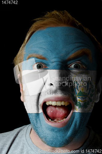 Image of Face of crazy angry man painted in colors of el salvador flag