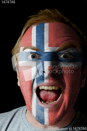 Image of Face of crazy angry man painted in colors of norway flag