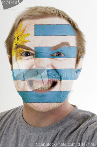 Image of Face of crazy angry man painted in colors of Uruguay flag