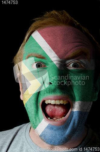 Image of Face of crazy angry man painted in colors of south africa flag