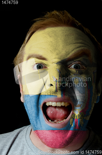 Image of Face of crazy angry man painted in colors of ecuador flag