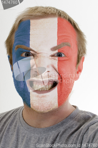 Image of Face of crazy angry man painted in colors of france flag