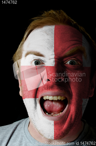 Image of Face of crazy angry man painted in colors of england flag