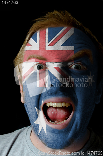 Image of Face of crazy angry man painted in colors of australia flag