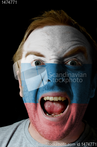 Image of Face of crazy angry man painted in colors of russia flag