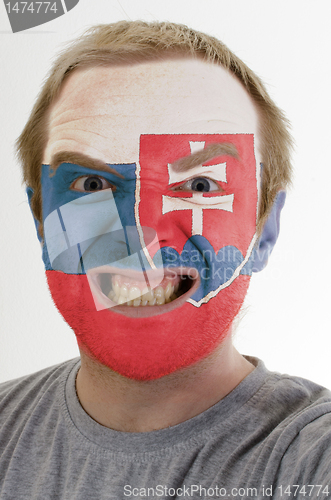 Image of Face of crazy angry man painted in colors of slovakia flag