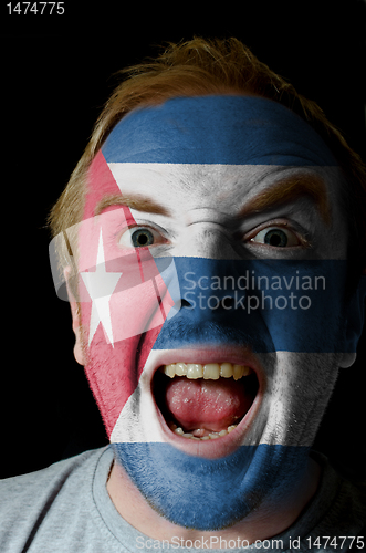 Image of Face of crazy angry man painted in colors of Cuba flag