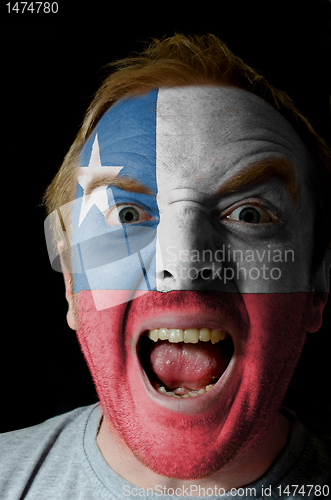 Image of Face of crazy angry man painted in colors of Chile flag