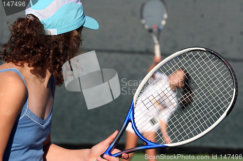 Image of Two girls playing tennis