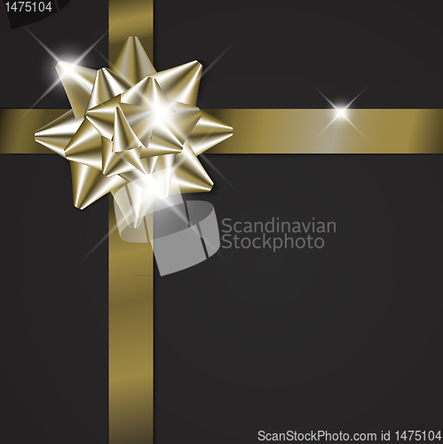 Image of Golden bow on a ribbon with black background