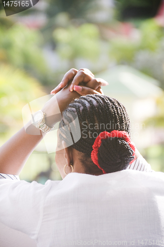 Image of Caribbean African woman with cornrow braids 