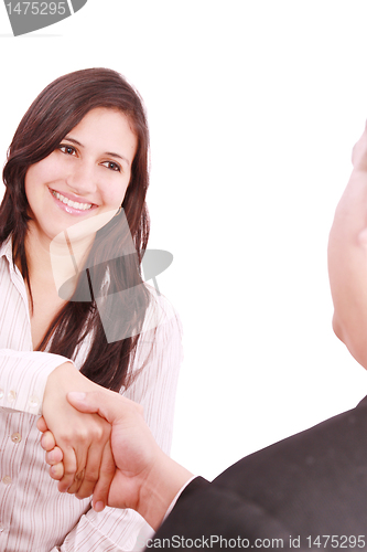 Image of Closeup of business people shaking hands over a deal at office -