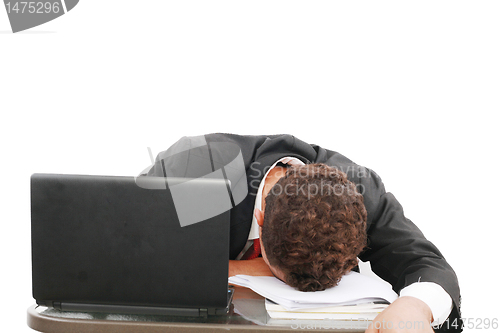 Image of A portrait of a tired businessman resting his head on books over