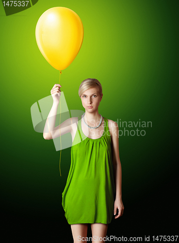 Image of blonde in green dress with the yellow balloon