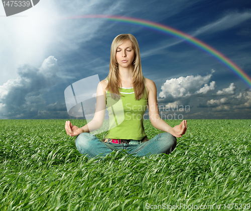 Image of Blonde in lotus pose in green grass