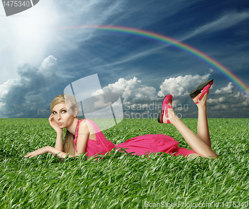 Image of Blonde in pink dress in green grass