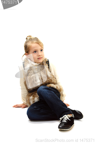 Image of Cute little girl in a fur vest.