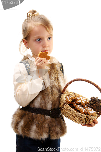 Image of Little girl with a basket and Christmas cookies.