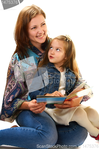 Image of Merry mother and the little girl reading a book. 