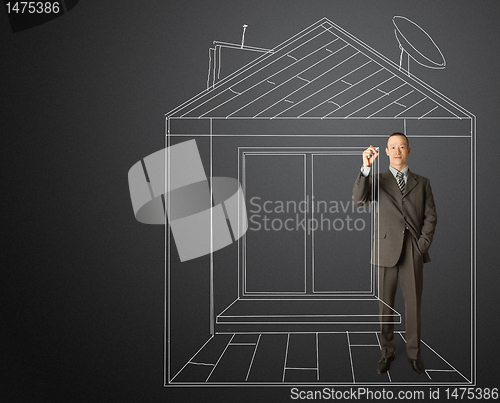 Image of asian businessman with marker in fictional house