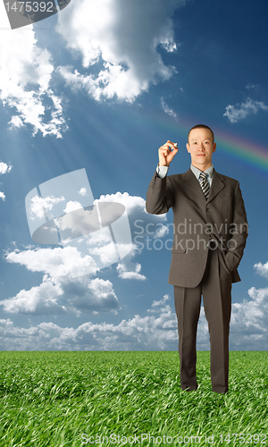 Image of asian businessman writting something outdoors