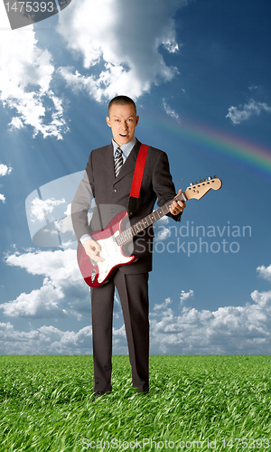 Image of asian guitarist playing outdoors