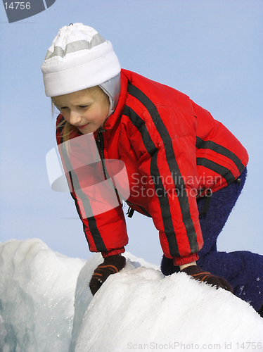 Image of Young girl looking into the crack in the ice field