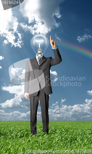 Image of full length businessman with lamp-head push the button outdoors