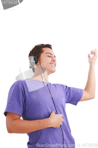 Image of Smiling young man listen music with headphones