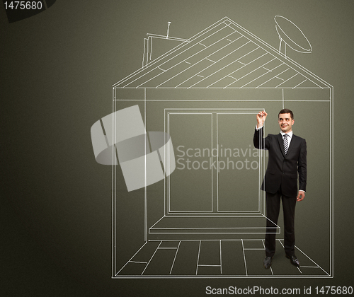 Image of businessman with marker in fictional house