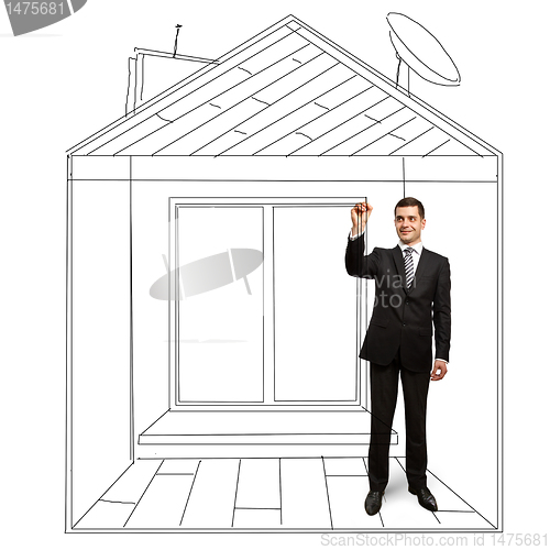 Image of businessman with marker in fictional house