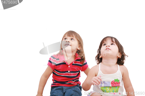 Image of Two little girl looking up, two and four years old, isolated on 